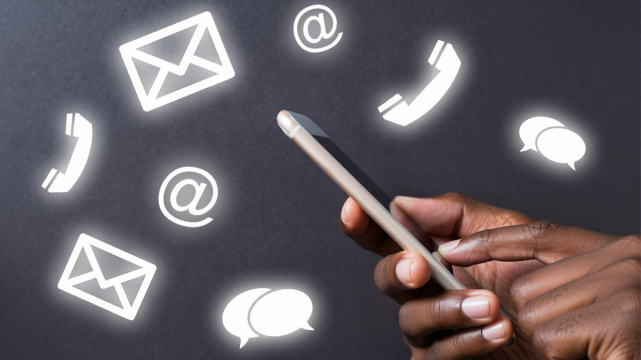 Person using a phone surrounded by communication symbols